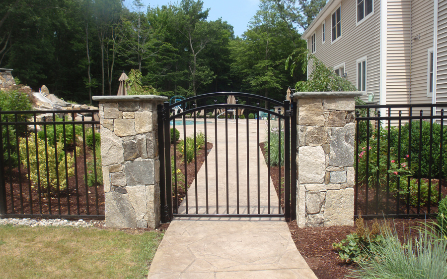 Pool fencing installation integrated into the backyard landscape